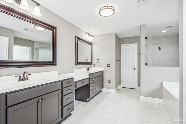 bathroom with vanity and shower with separate bathtub