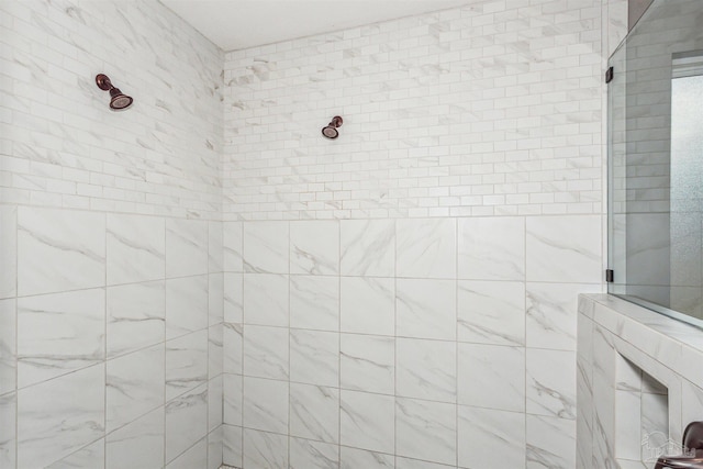 bathroom with a tile shower