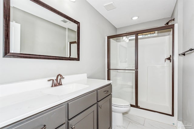 bathroom with vanity, toilet, and a shower with shower door