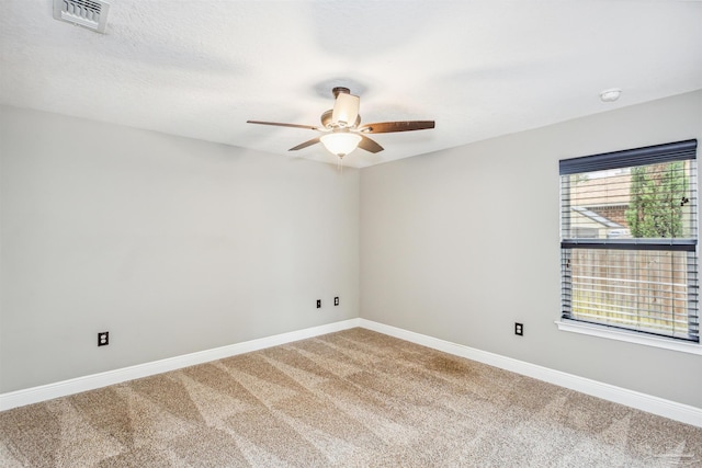 spare room with ceiling fan, carpet floors, and a textured ceiling