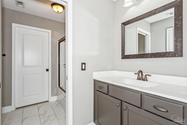 bathroom with vanity and shower / bath combination with glass door