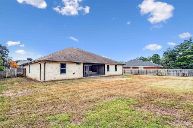 back of property featuring a yard