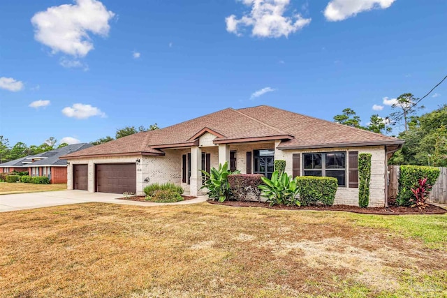 view of front facade with a garage and a front lawn