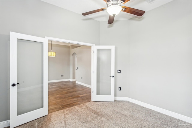 unfurnished room featuring french doors, hardwood / wood-style flooring, and ceiling fan