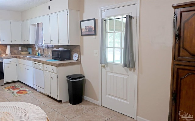 6150 Forest Pines Dr, Pensacola, FL 32526 - kitchen with white dishwasher, a sink, black microwave, decorative backsplash, and light tile patterned floors