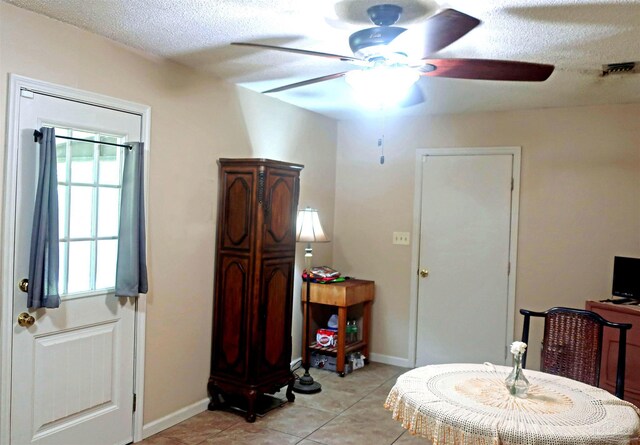 6150 Forest Pines Dr, Pensacola, FL 32526 - entrance foyer with a ceiling fan, a textured ceiling, baseboards, and light tile patterned floors