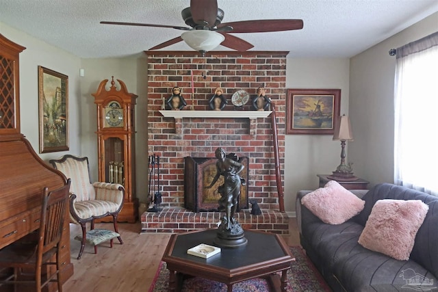 6150 Forest Pines Dr, Pensacola, FL 32526 - living room featuring a textured ceiling, wood finished floors, ceiling fan, and a brick fireplace