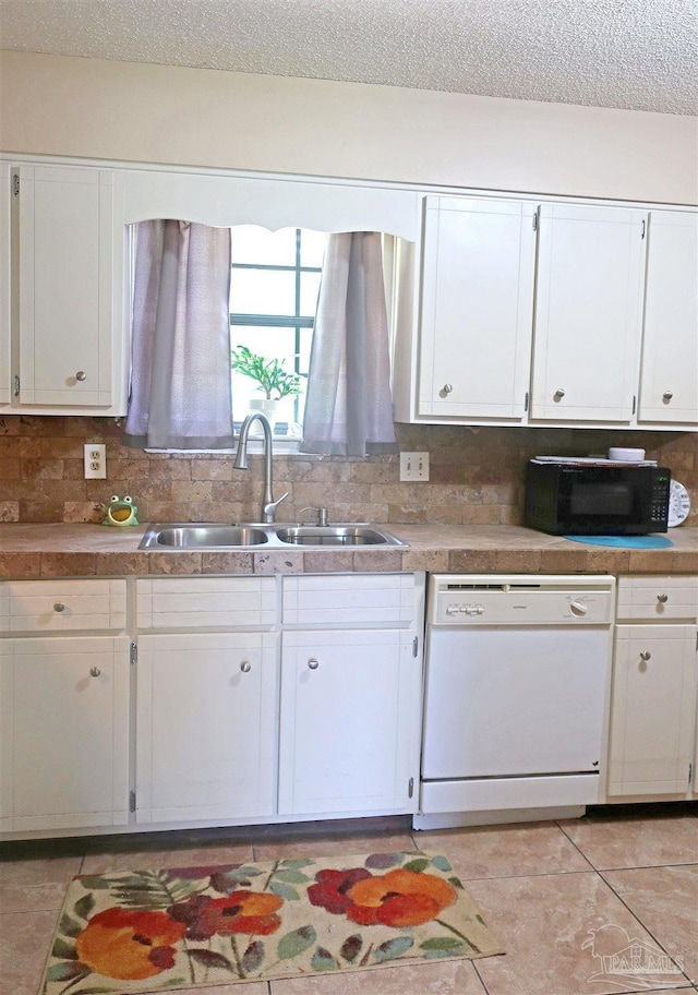 6150 Forest Pines Dr, Pensacola, FL 32526 - kitchen featuring dishwasher, a sink, black microwave, white cabinetry, and a textured ceiling