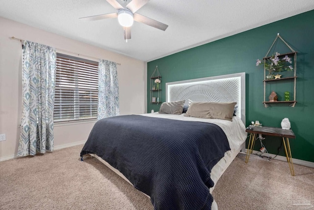 bedroom with ceiling fan, carpet, and a textured ceiling