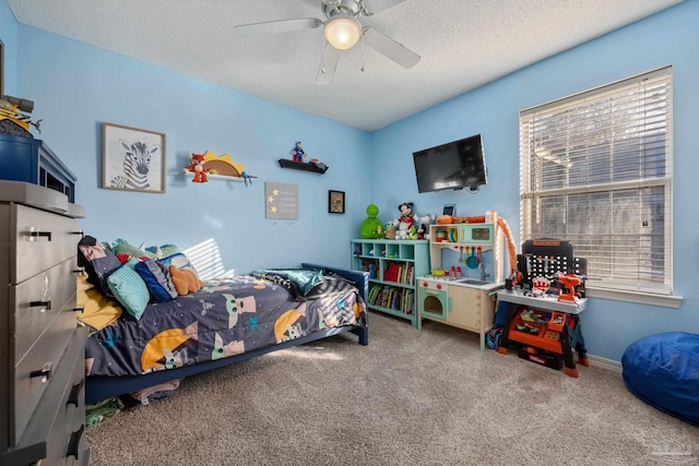 bedroom featuring ceiling fan, a textured ceiling, and carpet floors