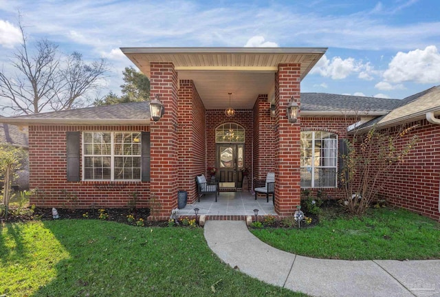 entrance to property with a lawn