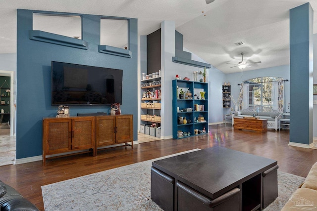 living room featuring a textured ceiling, vaulted ceiling, ceiling fan, and dark hardwood / wood-style flooring