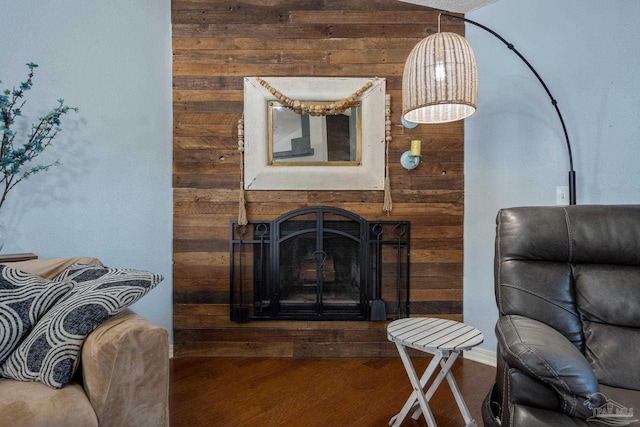 living room featuring wood-type flooring and wooden walls