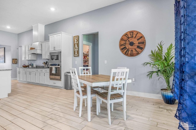 dining space with light wood-type flooring