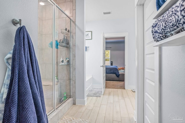 bathroom with a shower with door