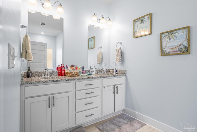 bathroom featuring vanity and wood-type flooring