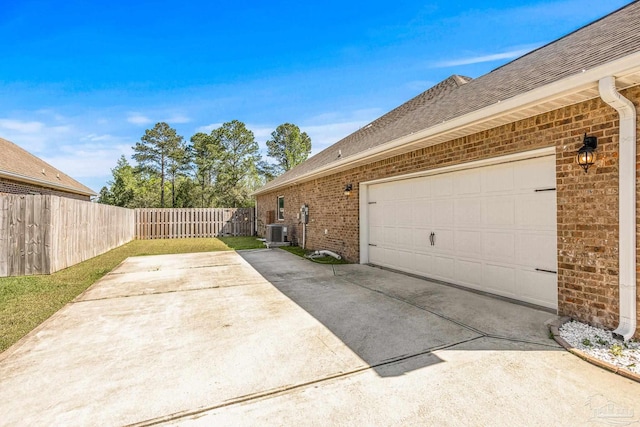 view of property exterior with a garage and central air condition unit