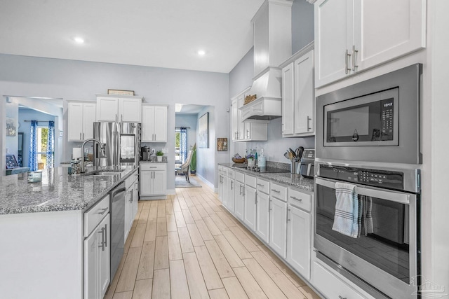 kitchen featuring white cabinetry, appliances with stainless steel finishes, and stone countertops