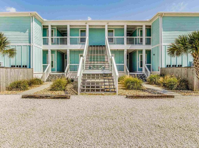 17290 Perdido Key Dr Unit A1, Pensacola, FL 32507 - view of front of house with board and batten siding, stairway, and fence