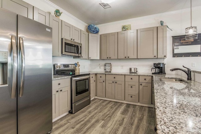 kitchen with hanging light fixtures, dark hardwood / wood-style flooring, appliances with stainless steel finishes, crown molding, and sink