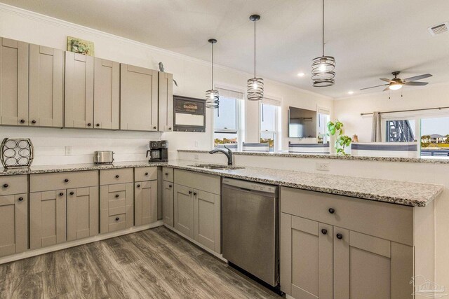 17290 Perdido Key Dr Unit A1, Pensacola, FL 32507 - kitchen with a peninsula, stainless steel dishwasher, a sink, a healthy amount of sunlight, and crown molding