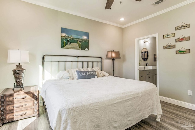 bedroom featuring ensuite bath, wood-type flooring, ornamental molding, and ceiling fan