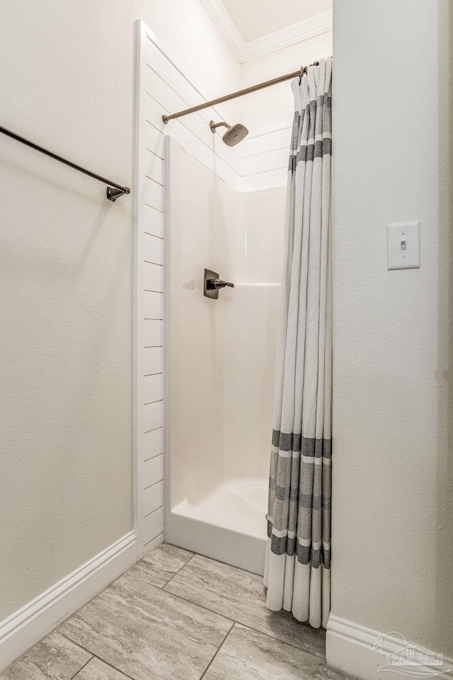 bathroom with wood-type flooring, ornamental molding, and curtained shower