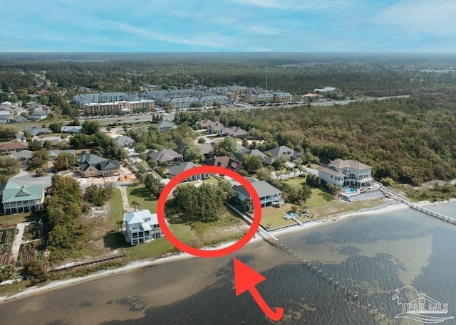 aerial view featuring a water view and a view of trees