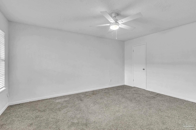 carpeted spare room with plenty of natural light, ceiling fan, and a textured ceiling