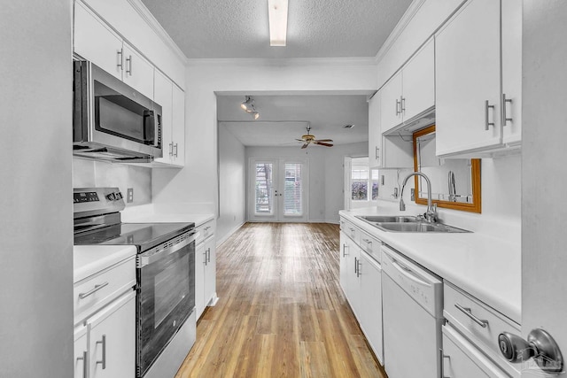 kitchen featuring light countertops, a ceiling fan, a sink, and appliances with stainless steel finishes
