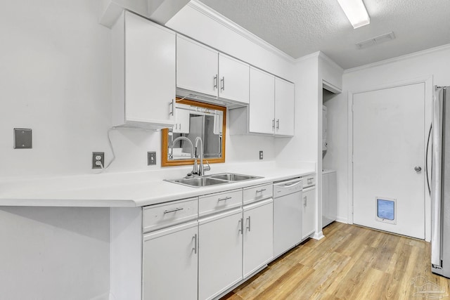 kitchen featuring white cabinetry, light countertops, a sink, visible vents, and dishwasher