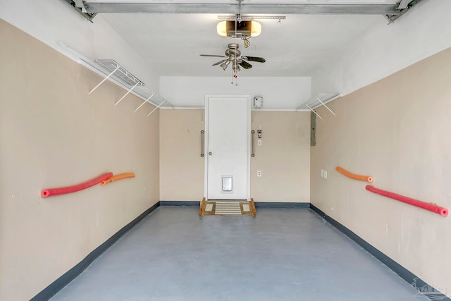 garage featuring a ceiling fan, electric panel, baseboards, and a garage door opener