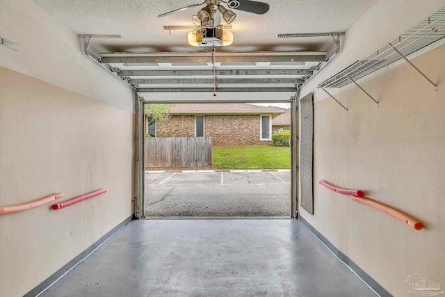 garage featuring a garage door opener and baseboards