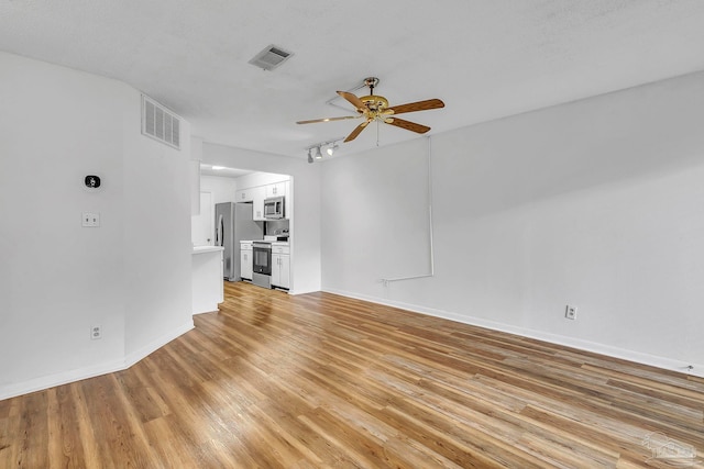 unfurnished living room featuring light wood-style flooring, baseboards, ceiling fan, and visible vents