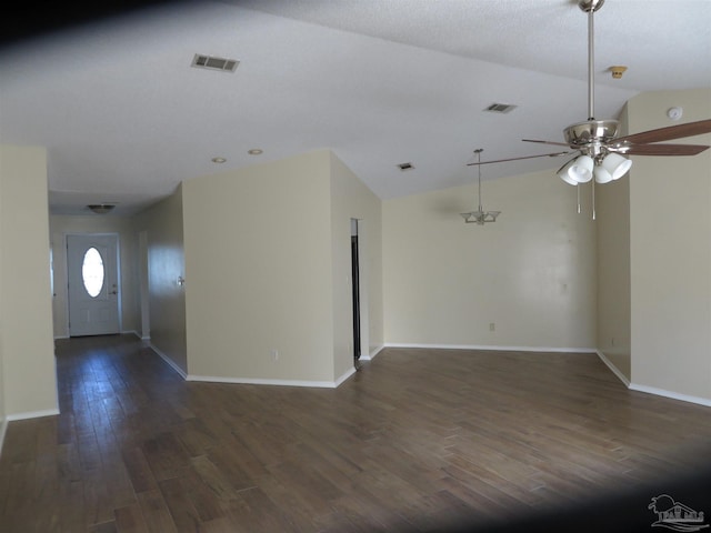 unfurnished living room featuring dark wood-style floors, vaulted ceiling, a ceiling fan, and visible vents