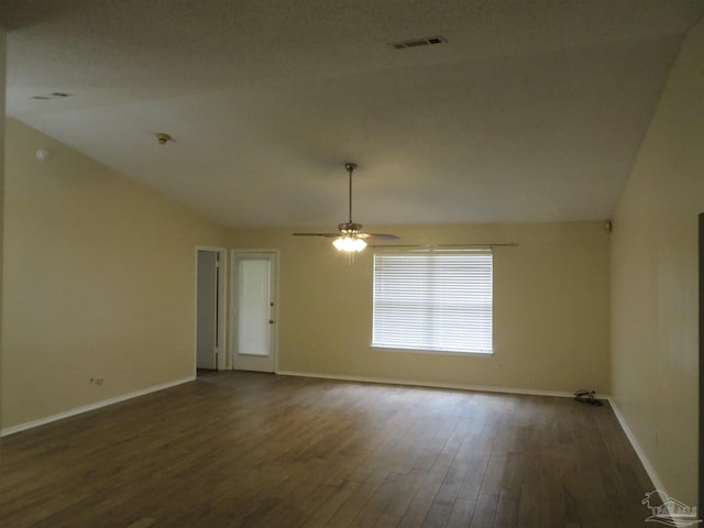 unfurnished room with lofted ceiling, ceiling fan, and dark wood-type flooring