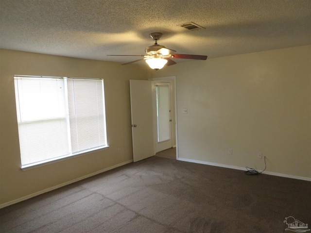 spare room with ceiling fan, a textured ceiling, and carpet flooring