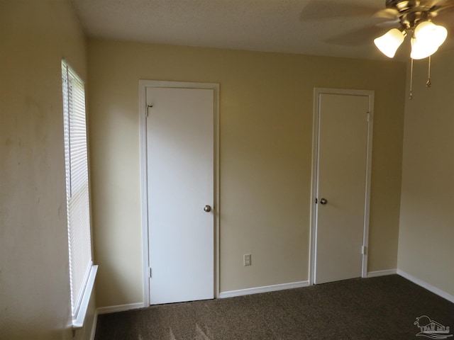unfurnished bedroom with baseboards, a ceiling fan, and carpet floors