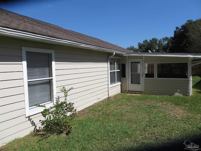 view of home's exterior with a yard