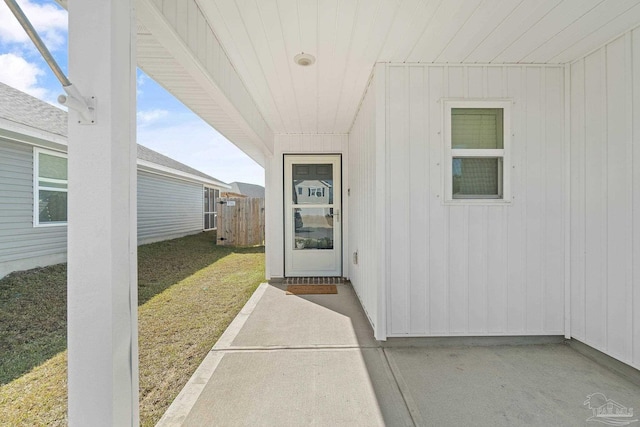 5252 Peach Dr, Pace, FL 32571 - property entrance featuring a patio area, a yard, and board and batten siding