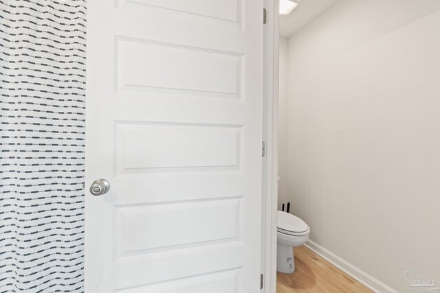 5252 Peach Dr, Pace, FL 32571 - bathroom with wood finished floors, baseboards, and toilet