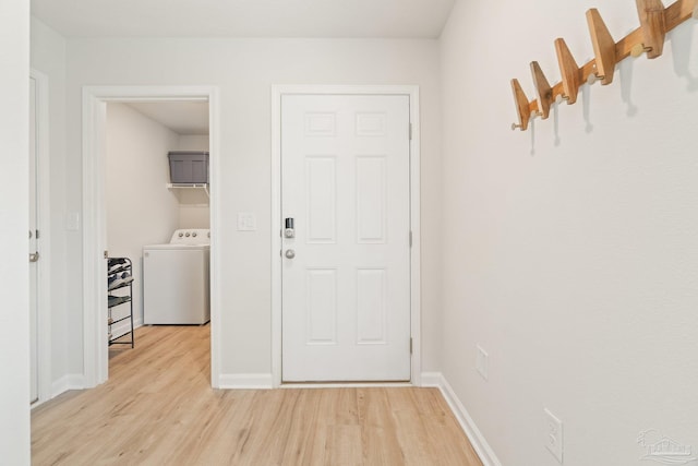 5252 Peach Dr, Pace, FL 32571 - foyer featuring washer / clothes dryer, light wood-style floors, and baseboards