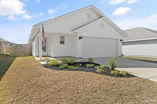 5252 Peach Dr, Pace, FL 32571 - view of side of property with an attached garage, a porch, and concrete driveway