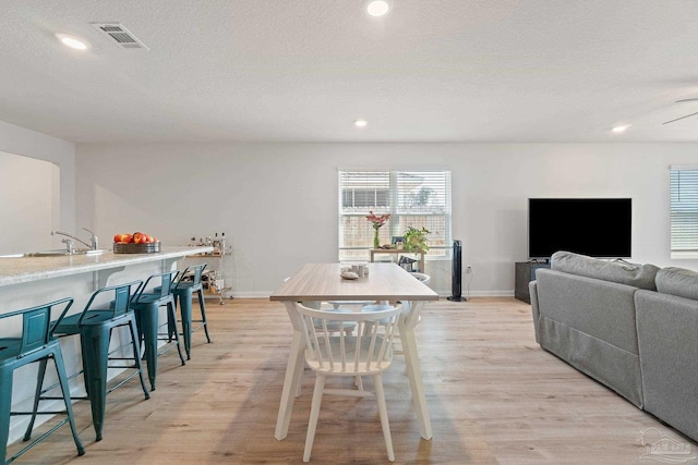 5252 Peach Dr, Pace, FL 32571 - dining space featuring light wood-type flooring, baseboards, recessed lighting, and a textured ceiling