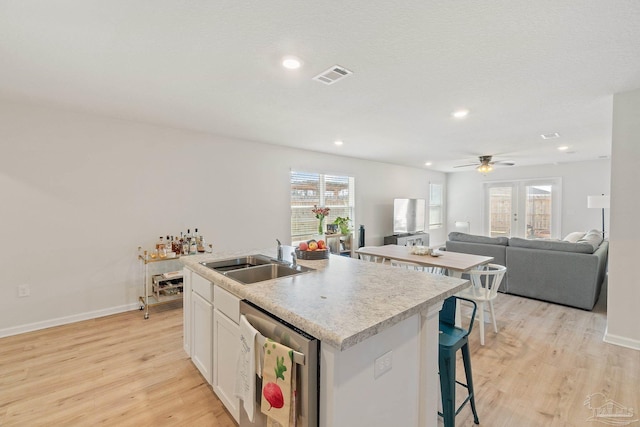 5252 Peach Dr, Pace, FL 32571 - kitchen with a sink, dishwasher, an island with sink, light wood-style flooring, and open floor plan