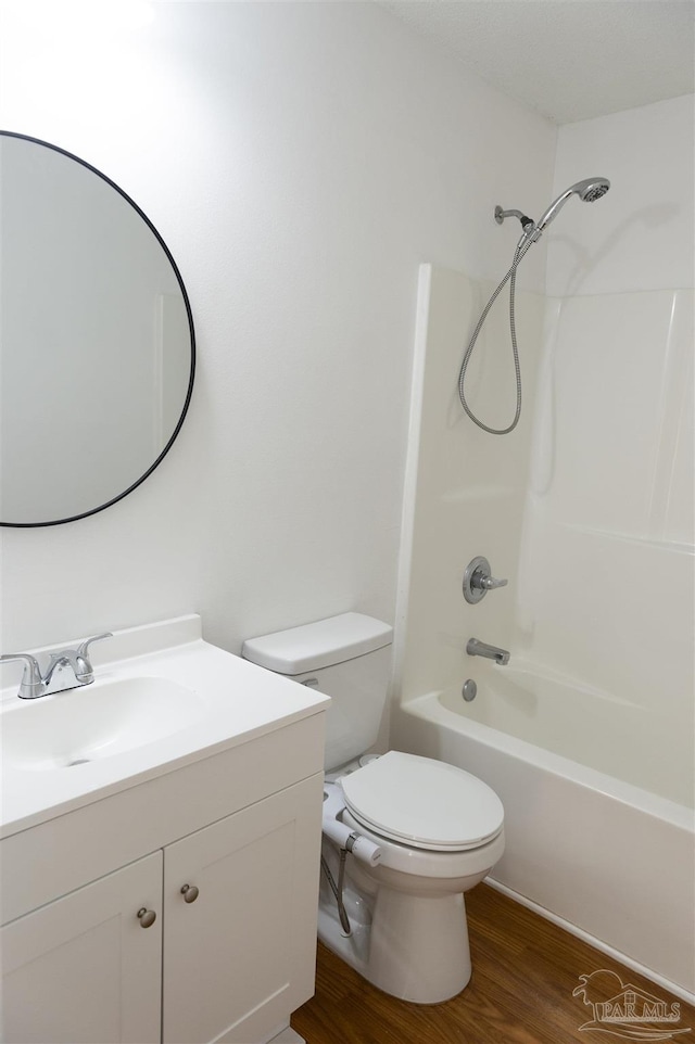 bathroom featuring shower / bath combination, vanity, toilet, and wood finished floors