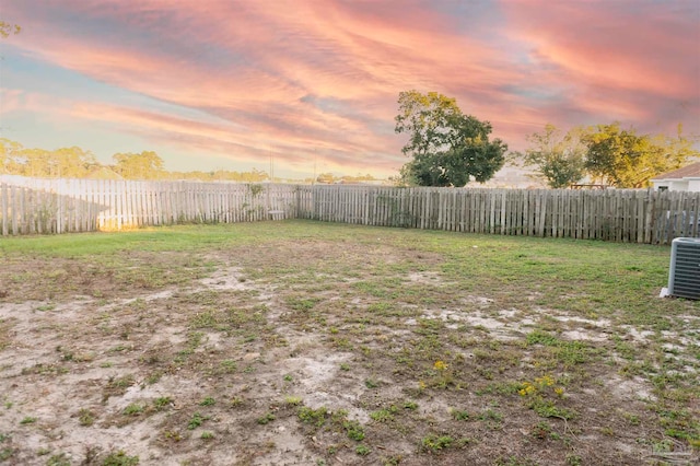 yard at dusk with central AC unit