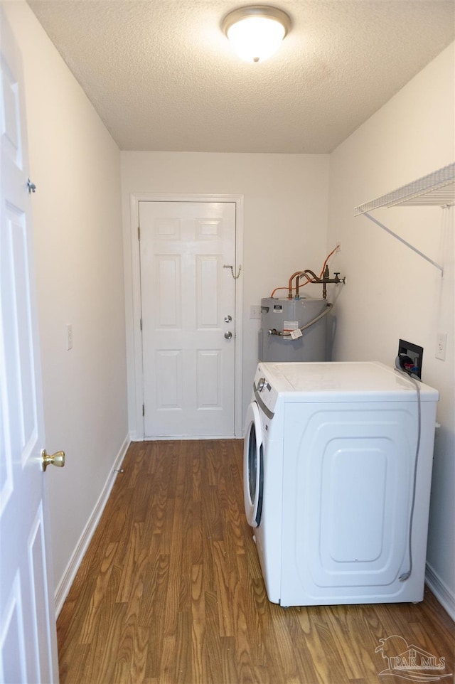 clothes washing area with a textured ceiling, laundry area, wood finished floors, and electric water heater