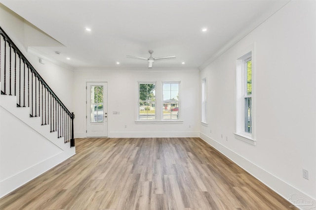 interior space with crown molding, recessed lighting, light wood-style floors, baseboards, and stairs