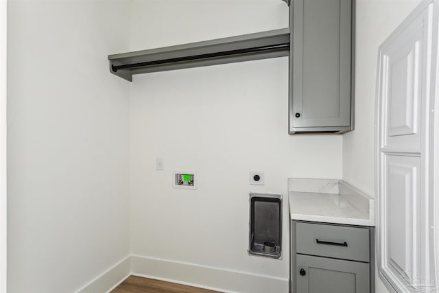 clothes washing area with laundry area, baseboards, dark wood-type flooring, washer hookup, and electric dryer hookup